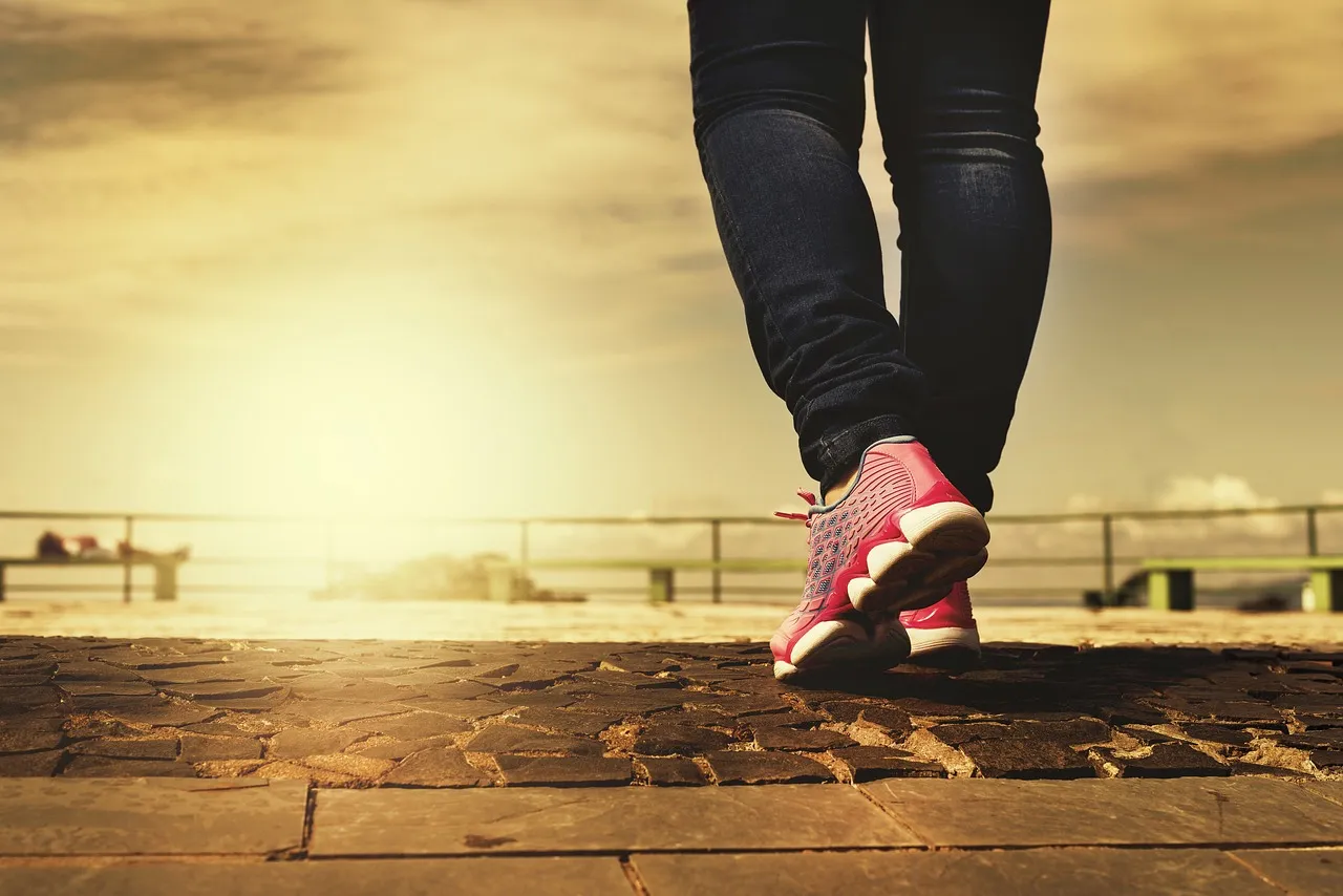 A person walking outdoors in pink sneakers