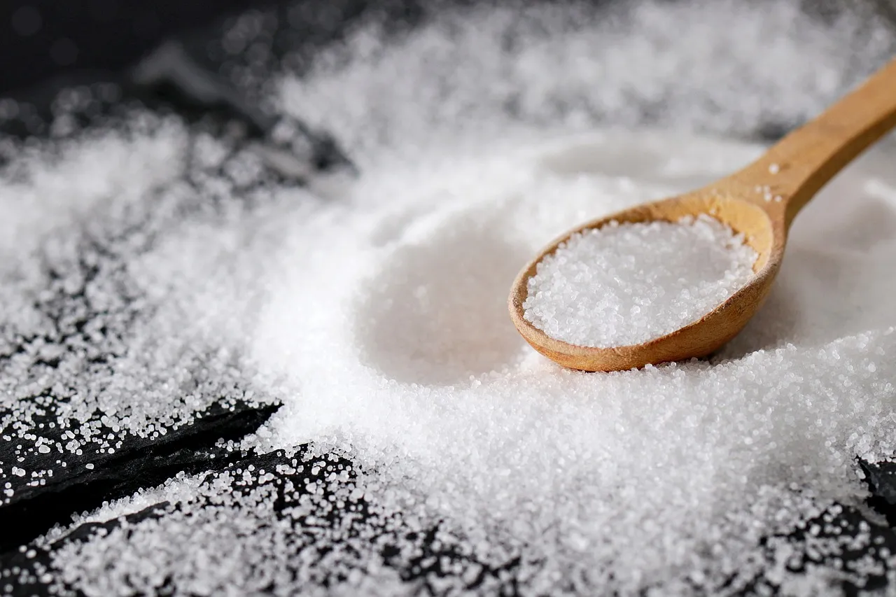 A wooden spoon full of salt